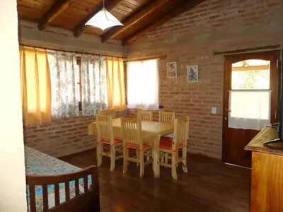 a dining room with a table and chairs at El Caserio Casas de Campo in Villa Cura Brochero