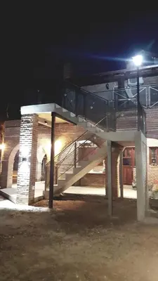 a staircase in front of a building at night at Apart y Suite Portal del Luz in Mina Clavero