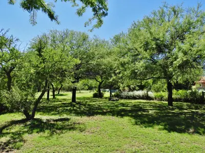 a park with trees in a grassy field at Posada Terracota in Nono