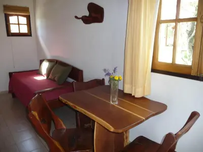 a living room with a table and a couch at Posada Terracota in Nono