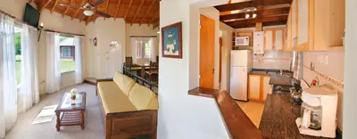 a living room and kitchen with a couch and a table at Solar Encantado Cabañas & Chalet in Villa General Belgrano