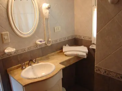 a bathroom with a sink and a phone on the wall at Solar Encantado Cabañas & Chalet in Villa General Belgrano