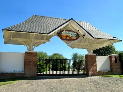 a pavilion with a sign in front of a fence at Solar Encantado Cabañas & Chalet in Villa General Belgrano