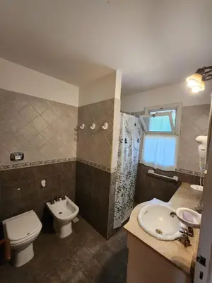 a bathroom with a toilet and a sink and a shower at Solar Encantado Cabañas & Chalet in Villa General Belgrano