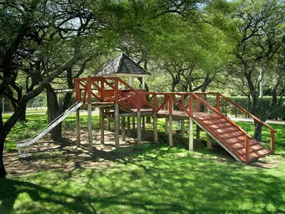a playground with a slide and a tree at Solar Encantado Cabañas & Chalet in Villa General Belgrano