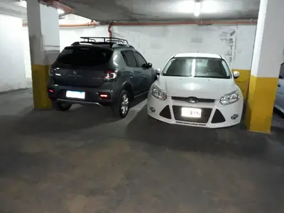 two cars parked in a parking garage at Departamento Luxor in Villa Carlos Paz