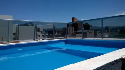 a swimming pool on the roof of a building at Departamento Luxor in Villa Carlos Paz