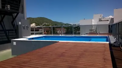 a swimming pool on the roof of a building at Departamento Luxor in Villa Carlos Paz
