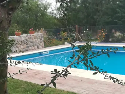 a swimming pool in a yard with a fence at Cabañas Valentina in Cortaderas