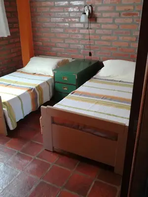 two beds sitting next to each other in a room at Cabañas Valentina in Cortaderas