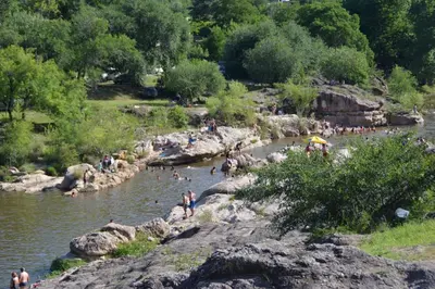 a group of people swimming in a river at La Colina in Villa Carlos Paz
