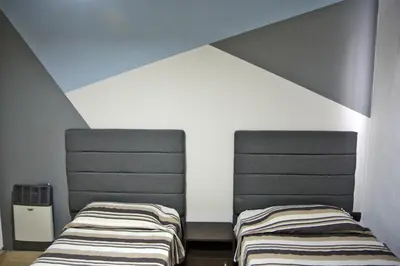 two beds sitting next to each other in a room at La Colina in Villa Carlos Paz