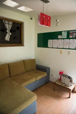 a living room with a couch and a table at Feliza Hostel in Villa Carlos Paz