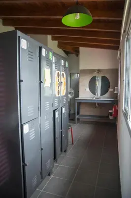 a row of lockers in a bathroom with a sink at Feliza Hostel in Villa Carlos Paz