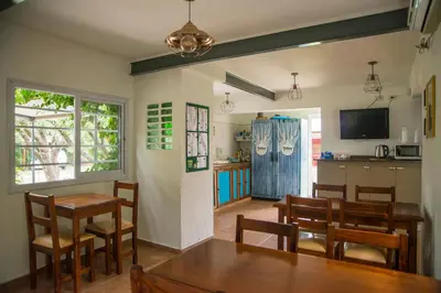 a kitchen and dining room with a table and chairs at Feliza Hostel in Villa Carlos Paz