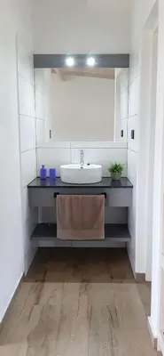 a bathroom with a sink and a mirror at Cabañas Buena Vista - Santa Rosa in Santa Rosa de Calamuchita