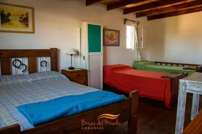 a bedroom with two beds in a room at Cabañas Brisas Del Mirador in Bialet Massé