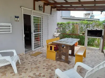 a patio with a wooden table and chairs at Cabañas Brisas Del Mirador in Bialet Massé