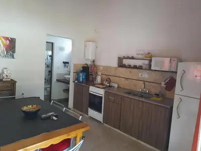 a kitchen with a white refrigerator and a counter top at Cabañas Brisas Del Mirador in Bialet Massé