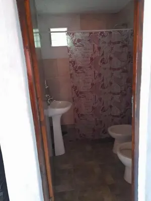 a bathroom with two toilets and a sink at Cabañas Brisas Del Mirador in Bialet Massé