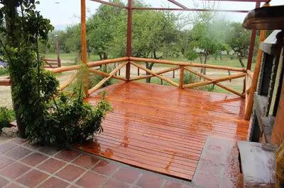 a porch with a wooden deck with a fence at Cabatanti in Tanti