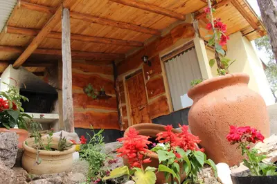 a large vase with flowers in front of a house at Cabatanti in Tanti