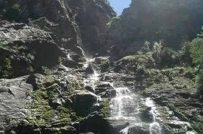 a waterfall on the side of a rocky mountain at Cabatanti in Tanti