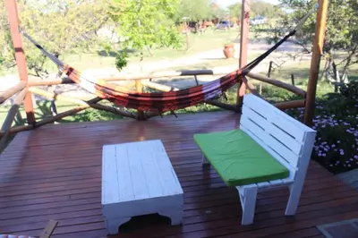 a hammock and two benches on a deck with a hammock at Cabatanti in Tanti
