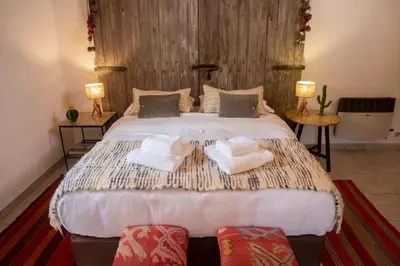 a bedroom with a large bed with towels on it at La Hondonada in San Javier
