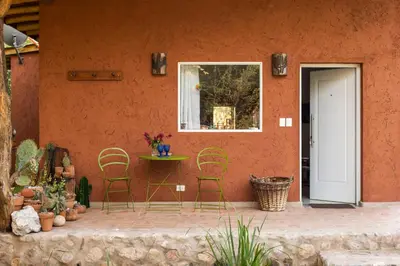 a patio with chairs and a table and a window at La Hondonada in San Javier