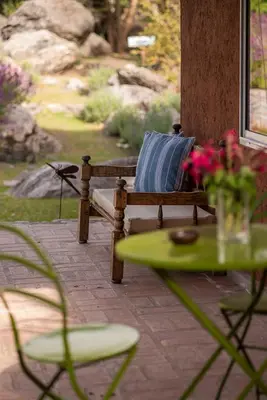 a wooden bench with a blue pillow on a patio at La Hondonada in San Javier