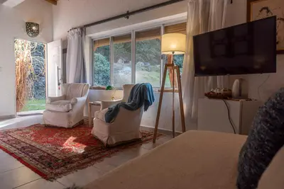a living room with two chairs and a flat screen tv at La Hondonada in San Javier