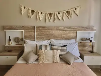a bedroom with a large bed with a wooden headboard at Sierras Encantadas Cabañas in Panaholma