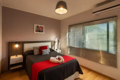 a bedroom with a bed with a baby on it at Sierras Encantadas Cabañas in Panaholma