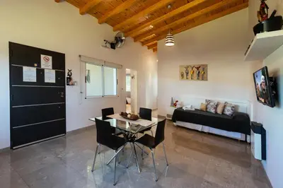 a living room with a table and a couch at Sierras Encantadas Cabañas in Panaholma