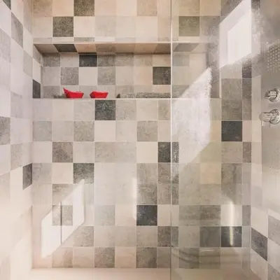 a shower with red shoes on a tiled floor at Lake Point Residencias in Villa Parque Siquiman