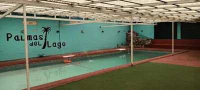a large swimming pool with the words pima el lagapo on the wall at Palmas del Lago in Villa Carlos Paz