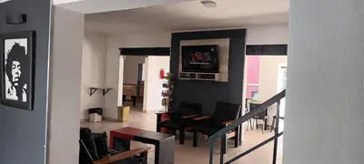 a living room with a tv on a wall at Palmas del Lago in Villa Carlos Paz