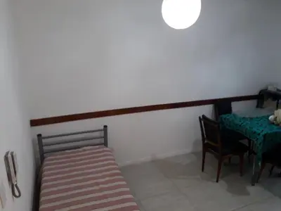 a room with a table and a bench and a table and chairs at Edificio Hipolito Irigoyen in Villa Carlos Paz