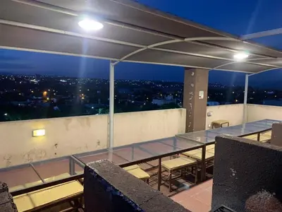 a room with a view of a city at night at Edificio Hipolito Irigoyen in Villa Carlos Paz