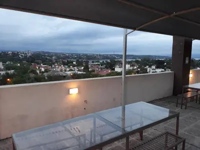 a glass table on a balcony with a view at Edificio Hipolito Irigoyen in Villa Carlos Paz