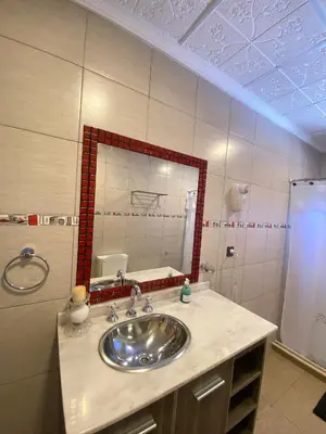 a bathroom with a sink and a mirror at Alto Valle in Nono