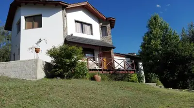 a large white house on top of a hill at Casas Altas VGB in Villa General Belgrano