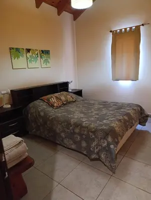 a bedroom with a bed in a room at Casas Altas VGB in Villa General Belgrano