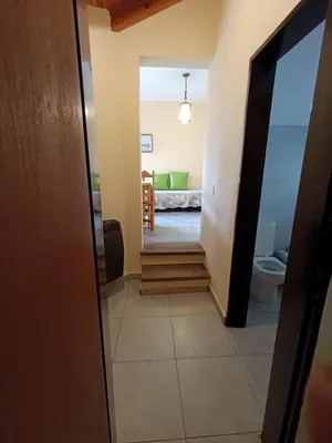 a hallway leading to a living room with a couch at Casas Altas VGB in Villa General Belgrano