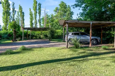 a car parked under a pavilion in a park at Finca El Amparo in Los Reartes