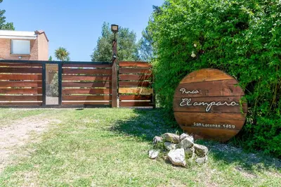 a large wooden barrel sitting next to a fence at Finca El Amparo in Los Reartes