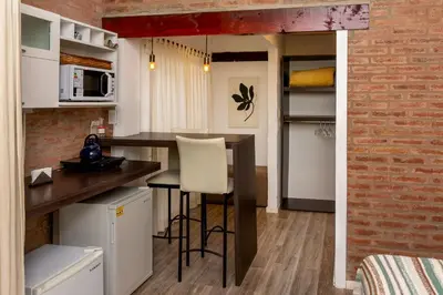 a kitchen with a counter and a bar in a room at Finca El Amparo in Los Reartes