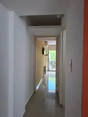 an empty hallway with a hallway leading into a room at Departamento Eutico in Villa Carlos Paz