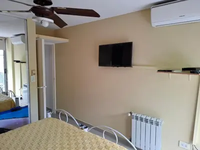 a living room with a tv on the wall at Departamento Eutico in Villa Carlos Paz